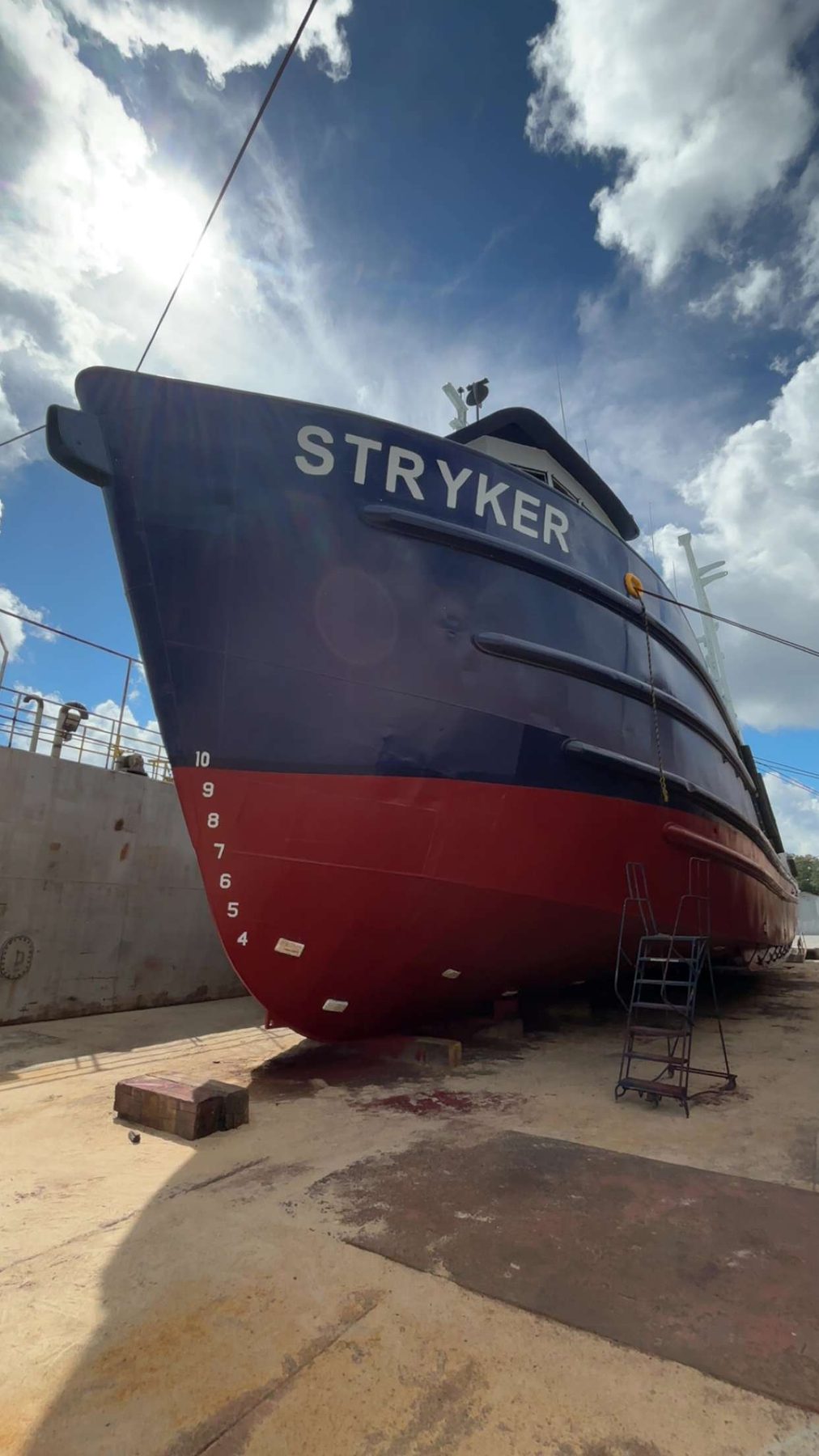 The Stryker in drydock, bow head-on, red anti-fouling below the waterline