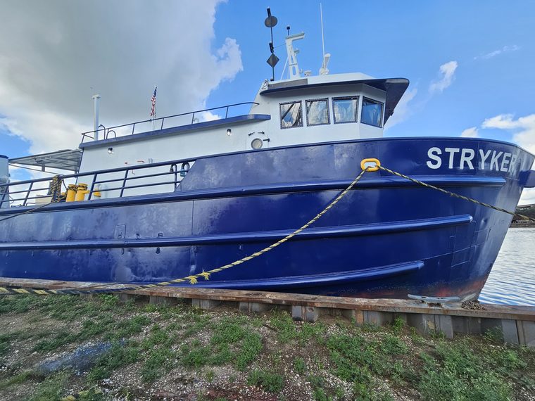 Three-quarter view of the Stryker on the hard, blue hull and white deckhouse